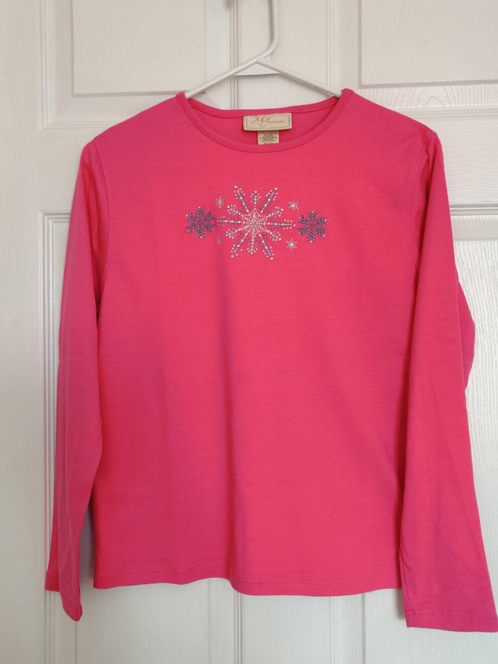 LS pink tee with snowflake design on front.